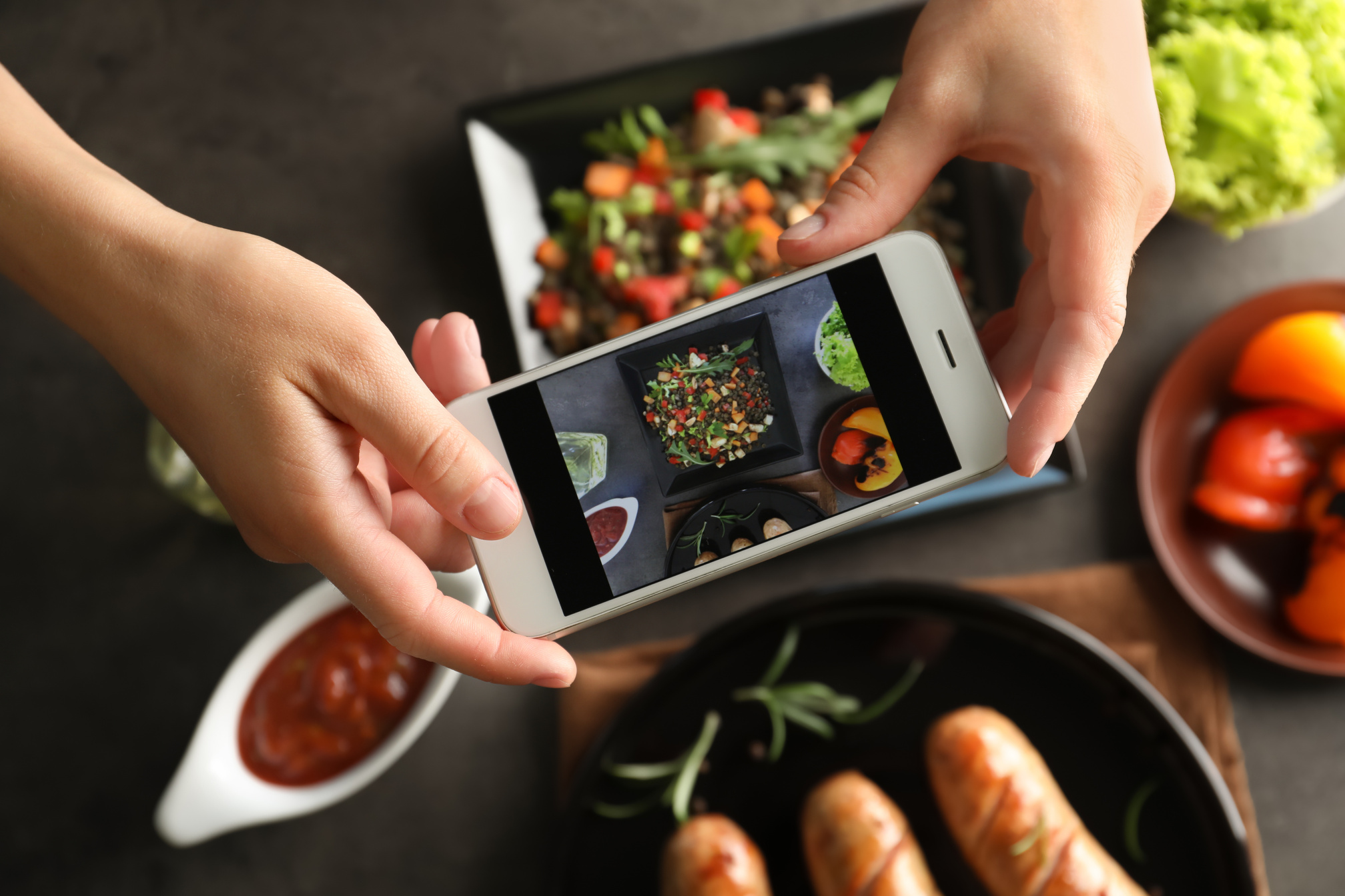 Female Blogger Taking Photo of Food with Smartphone Indoors